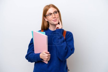 Téléchargez les photos : Jeune étudiante rousse femme isolée sur fond blanc penser une idée tout en levant les yeux - en image libre de droit