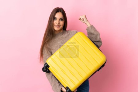 Photo for Young caucasian woman isolated on pink background in vacation with travel suitcase - Royalty Free Image