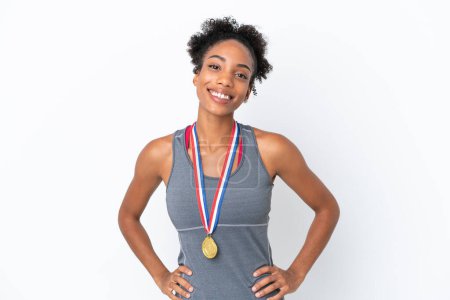 Photo for Young African American woman with medals isolated on white background posing with arms at hip and smiling - Royalty Free Image