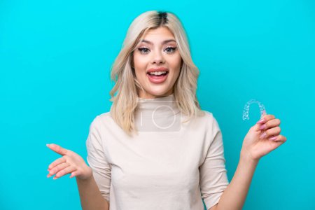Photo for Young Russian woman holding invisaging isolated on blue background with shocked facial expression - Royalty Free Image