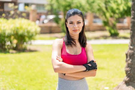 Photo for Young pretty sport woman at outdoors with confuse face expression - Royalty Free Image