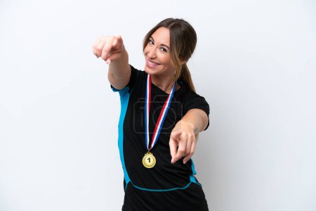 Photo for Young caucasian woman with medals isolated on white background points finger at you while smiling - Royalty Free Image