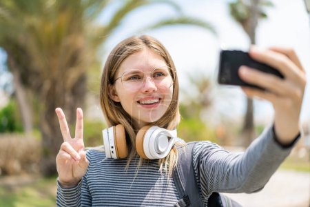 Photo for Young blonde woman at outdoors doing a selfie - Royalty Free Image