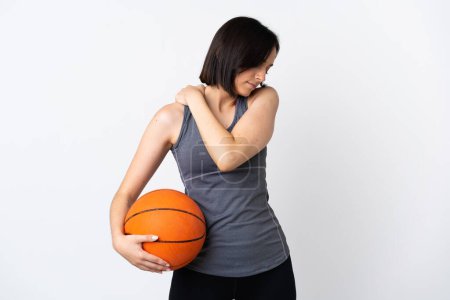 Téléchargez les photos : Jeune femme jouant au basket isolé sur fond blanc souffrant de douleur à l'épaule pour avoir fait un effort - en image libre de droit