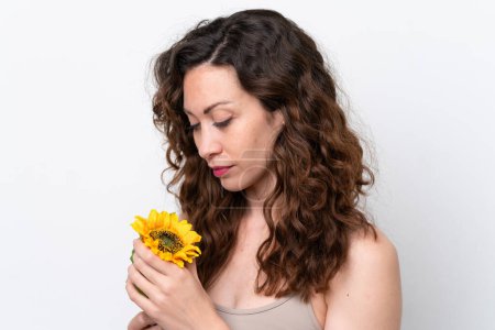 Photo for Young caucasian woman isolated on white background holding a sunflower. Close up portrait - Royalty Free Image