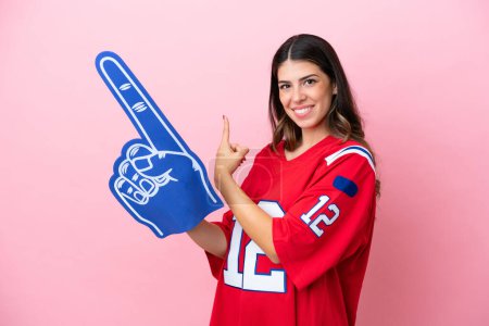 Photo for Young Italian fan woman with foam hand isolated on pink background pointing back - Royalty Free Image