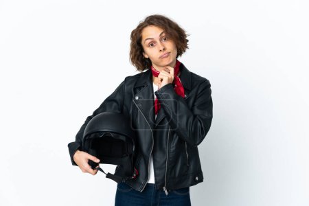 Photo for English woman holding a motorcycle helmet isolated on white background thinking an idea - Royalty Free Image