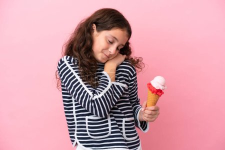 Photo for Little caucasian girl holding an ice cream isolated on pink background suffering from pain in shoulder for having made an effort - Royalty Free Image