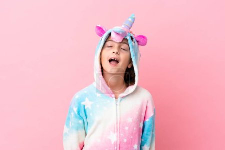 Photo for Little caucasian woman wearing a unicorn pajama isolated on pink background laughing - Royalty Free Image