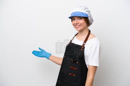 Photo for Fishmonger woman wearing an apron extending hands to the side for inviting to come - Royalty Free Image