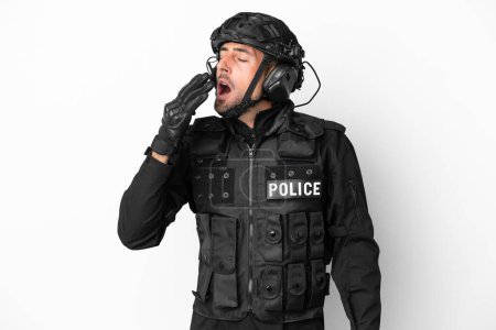 Foto de SWAT caucasian man isolated on white background yawning and covering wide open mouth with hand - Imagen libre de derechos