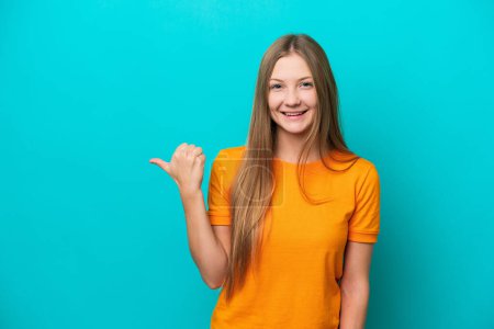 Photo for Young Russian woman isolated on blue background pointing to the side to present a product - Royalty Free Image