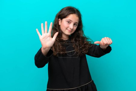 Photo for Little girl isolated on blue background counting six with fingers - Royalty Free Image