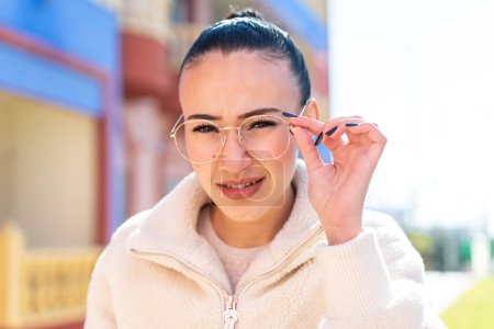 Photo for Young moroccan girl  at outdoors With glasses and frustrated expression - Royalty Free Image