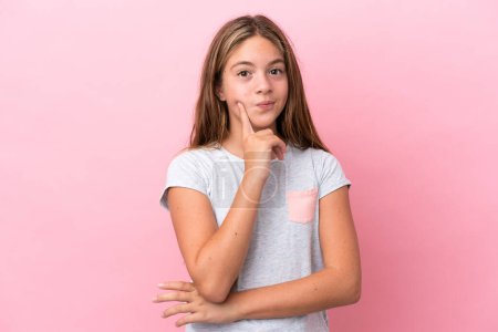 Photo for Little caucasian girl isolated on pink background and thinking - Royalty Free Image