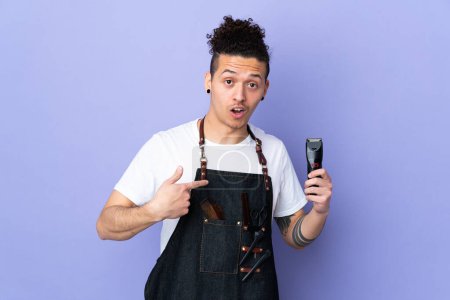Photo for Barber man in an apron over isolated purple background with surprise facial expression - Royalty Free Image