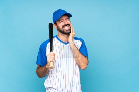Photo for Young man playing baseball over isolated blue background with toothache - Royalty Free Image
