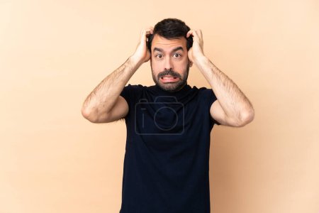 Photo for Caucasian handsome man over isolated background frustrated and takes hands on head - Royalty Free Image