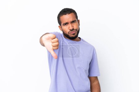Photo for Young Ecuadorian man isolated on white background showing thumb down with negative expression - Royalty Free Image