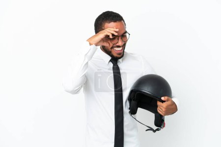 Photo for Young business latin man with a motorcycle helmet isolated on white background laughing - Royalty Free Image