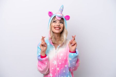 Photo for Young Russian woman with unicorn pajamas isolated on white background with fingers crossing - Royalty Free Image