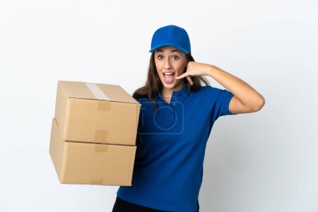 Photo for Young delivery woman over isolated white background making phone gesture. Call me back sign - Royalty Free Image