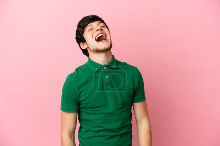 Photo for Young Russian man isolated on pink background laughing - Royalty Free Image