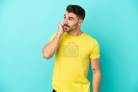 Photo for Young caucasian man isolated on blue background is a little bit nervous - Royalty Free Image