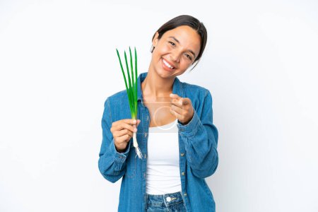 Photo for Young hispanic woman holding chive isolated on white background pointing front with happy expression - Royalty Free Image