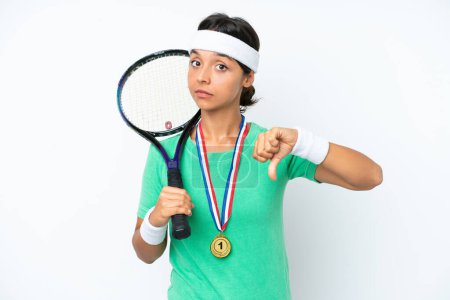 Photo for Young tennis player woman isolated on white background showing thumb down with negative expression - Royalty Free Image