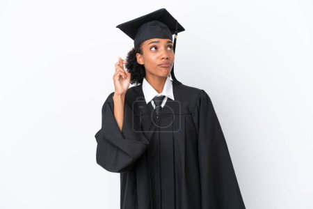 Photo for Young university graduate African American woman isolated on white background with fingers crossing and wishing the best - Royalty Free Image