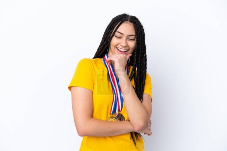 Photo for Teenager girl with braids and medals over isolated pink background looking to the side - Royalty Free Image