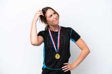 Photo for Young caucasian woman with medals isolated on white background having doubts and with confuse face expression - Royalty Free Image