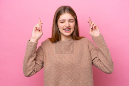 Photo for Teenager Russian girl isolated on pink background with fingers crossing - Royalty Free Image