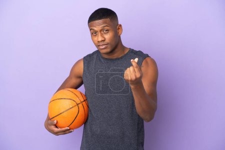 Photo for Young basketball latin player man isolated on purple background making money gesture - Royalty Free Image