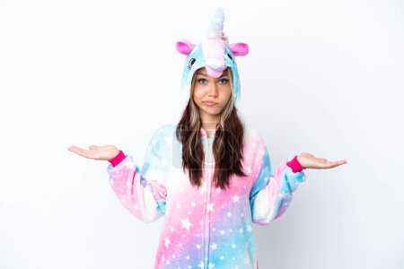 Photo for Young Russian woman wearing a unicorn pajama isolated on white background having doubts while raising hands - Royalty Free Image