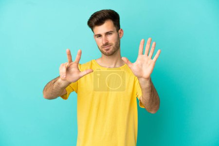 Photo for Young caucasian handsome man isolated on blue background counting eight with fingers - Royalty Free Image