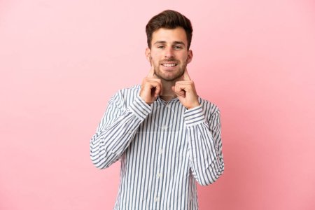 Photo for Young caucasian handsome man isolated on pink background smiling with a happy and pleasant expression - Royalty Free Image