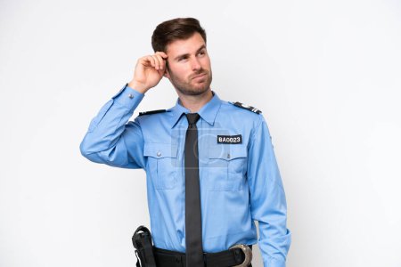 Foto de Young police caucasian man isolated on white background having doubts and with confuse face expression - Imagen libre de derechos