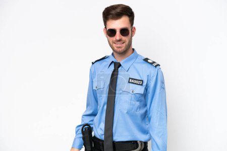Foto de Young police caucasian man isolated on white background with glasses and happy - Imagen libre de derechos