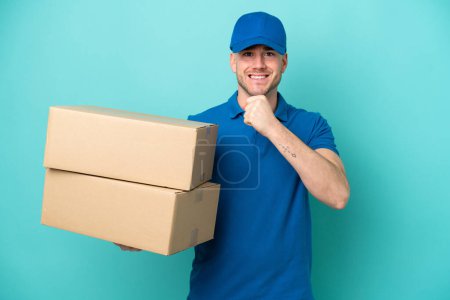 Photo for Delivery caucasian man isolated on blue background celebrating a victory - Royalty Free Image