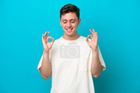 Photo for Young handsome Brazilian man isolated on blue background in zen pose - Royalty Free Image