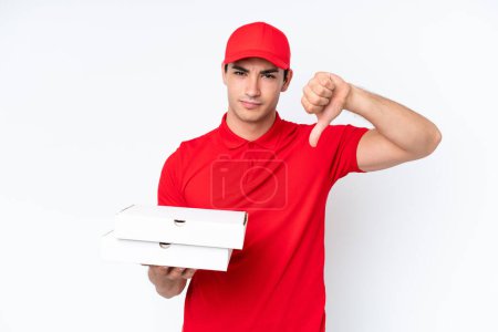 Photo for Pizza delivery caucasian man with work uniform picking up pizza boxes isolated on white background showing thumb down with negative expression - Royalty Free Image