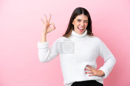 Téléchargez les photos : Young Italian woman isolated on pink background showing ok sign with fingers - en image libre de droit