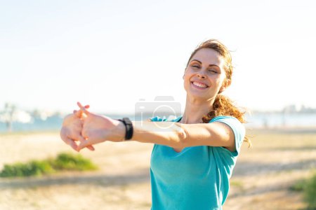 Photo for Young woman at outdoors doing sport and stretching - Royalty Free Image