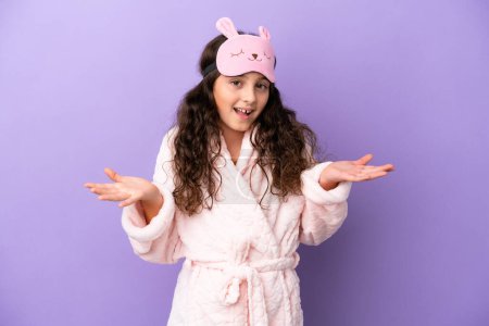 Photo for Little caucasian girl in pajamas isolated on purple background with shocked facial expression - Royalty Free Image