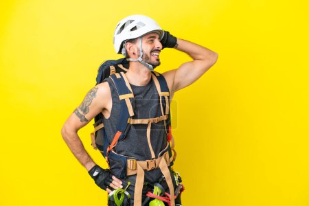 Young caucasian rock climber man isolated on yellow background has realized something and intending the solution