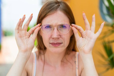 Photo for Young French girl at outdoors With glasses and frustrated expression - Royalty Free Image