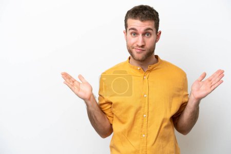Photo for Young caucasian man isolated on white background having doubts while raising hands - Royalty Free Image
