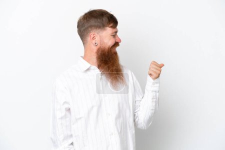 Photo for Redhead man with long beard isolated on white background pointing to the side to present a product - Royalty Free Image